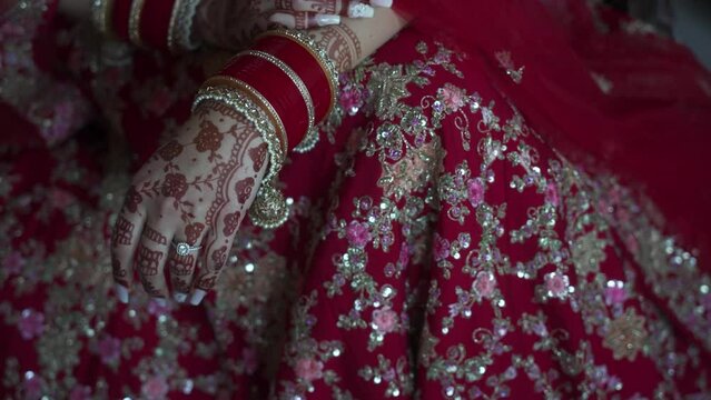 Indian bride with hands tattooed with henna on wedding day. Handheld