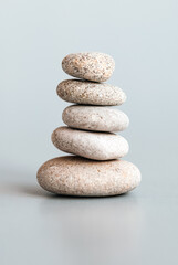 Stones stacked in pyramid, balance, stability, zen, meditation, body mind and soul harmony concept