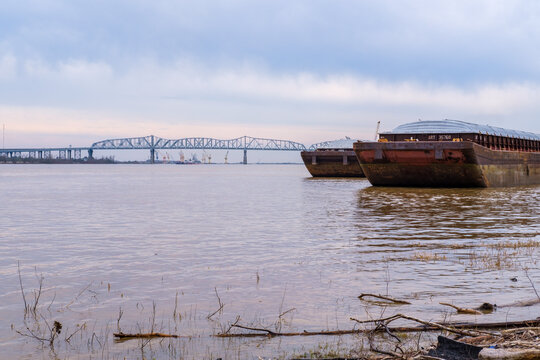 Two barges docked on the Mississippi River with the Huey P. Long Bridge in the background on March 3, 2020 in Jefferson, LA, USA
