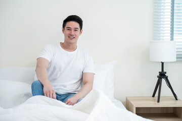 Portrait of Asian handsome male in pajamas smile and looking at camera. 