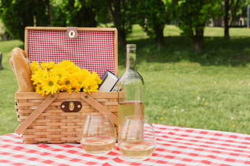 wine and a picnic basket with flowers 