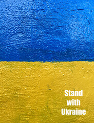 Stand with Ukraine losung on wall painted as Ukrainian flag
