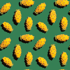 Yellow pitahaya, dragon fruit. Shambolic seamless pattern of yellow pitahaya halves on a green background. Tropical pattern