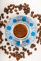 Traditional turkish coffee and coffee beans. Turkish Coffee on coffee beans background. close-up from above