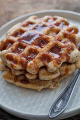 Waffles with caramel sauce. Wooden background. Top view. 