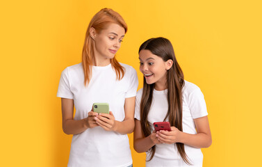 shopping app. modern communication technology. mother and daughter typing and texting.