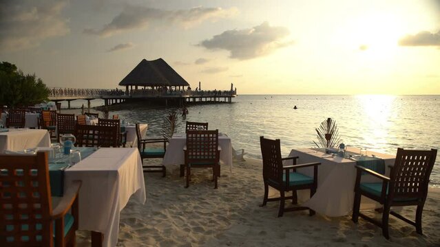 Served tables in the restaurant on the ocean in anticipation of visitors.