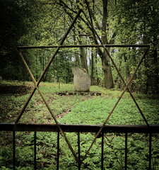 Monument to the extermination of the Jews behind the fence.