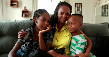 Mother and hugging with children at home, African mixed race family, mom posing with kids