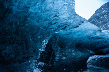 Interior of a glacial cave with a beautiful blue color, copy space. 