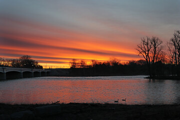 The sun rises over the bridge and the Maumee River in Waterville Ohio.