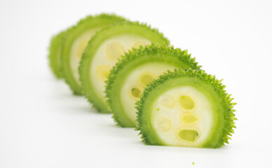 very fresh spiny gourd slices isolated on white background, also known as korolla