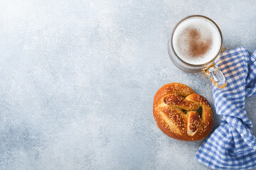 Bavarian pretzels and glass of lager beer. Oktoberfest food menu, traditional salted pretzels on...
