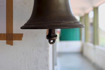 portrait view of bell hanging in school building