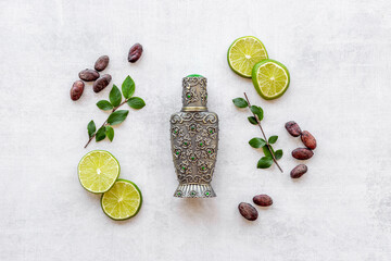 Silver bottle of arabian oud perfume with ingredients