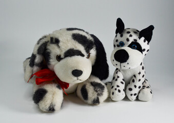 two Dalmatian puppies.a plush toy on a white background.