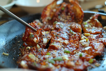 Pick up Braised Half-dried Pollack with chopsticks.