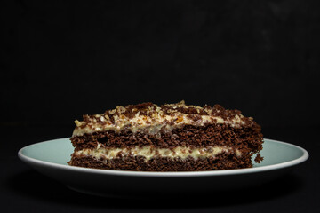 Delicious and easy dessert. Homemade baking. Chocolate cake with banana filling on a black background.