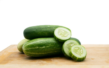 whole cucumber with some pieces isolated on white background