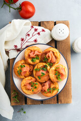 Yorkshire pudding. Traditional English Yorkshire pudding with salmon and radish microgreens side dish on white plate and light grey background table. Top view.