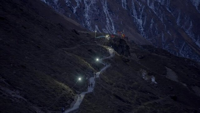 Pilgrims Trekking On Himalayan Range At Dusk. Pilgrimage In Kedarnath, India. high angle, wide