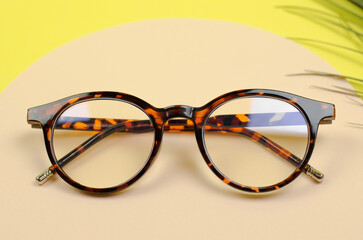 Stylish women's glasses on a colored background. Leopard glasses