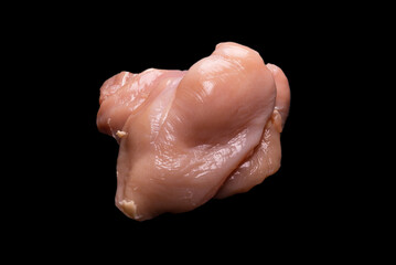 Raw chicken fillet isolated on a black background.