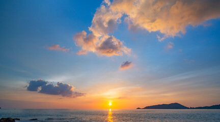 Naklejka na ściany i meble Sunset or sunrise sky clouds over sea sunlight in Phuket Thailand Amazing nature landscape seascape