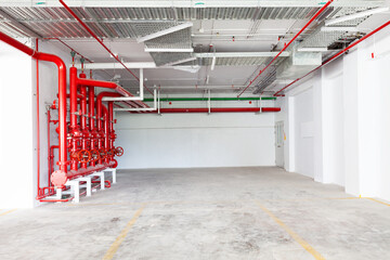 Parking garage interior, industrial building, hydrant with water hoses and fire extinguisher...