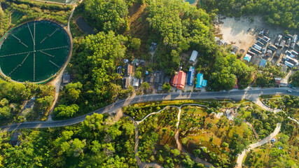 Obraz premium Aerial view of countryside road and village in the morning at Thailand