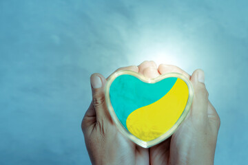 Heart shape with Ukrainian flag in men's hands