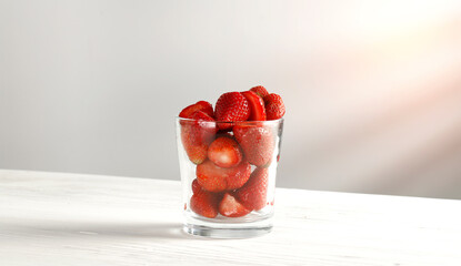 Wooden white table with watermelon and empty space, shadows on the wall 