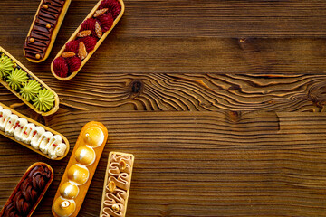 Sweet bakery eclairs with creamy decor, top view