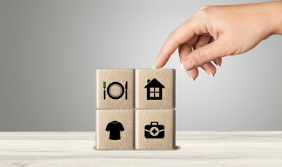 The investor's concept, wooden cube with concept work from home, Planning to buy property concept ,food Clothing, housing, medicine, four basic human needs concept.