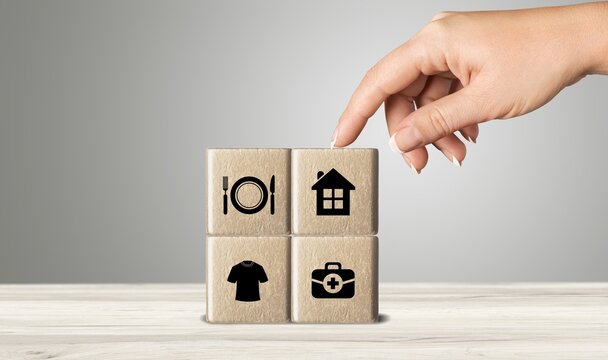 The investor's concept, wooden cube with concept work from home, Planning to buy property concept ,food Clothing, housing, medicine, four basic human needs concept.