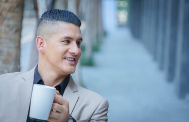 Businessman drinking coffee.Smiling of businessman.