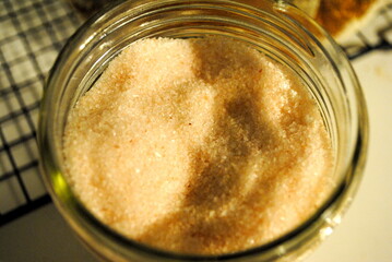 Himalayan pink salt in a glass mason jar open close up macro