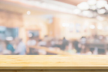Empty wood table top with cafe restaurant interior blurred background