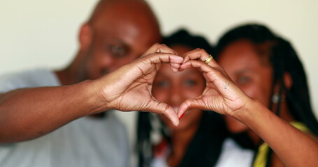 Black family making heart symbol with hands. African mixed race ethnicity. Love concept