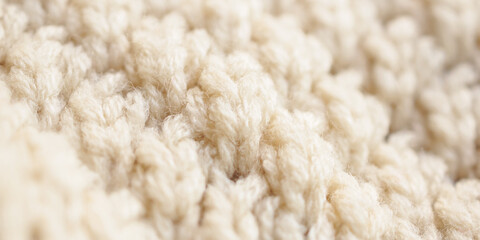 closeup beige knitted woolen fabric texture background