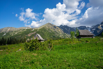 Old mountain huts against the great peaks. Gasienicowa Valley. Tatra Mountains.