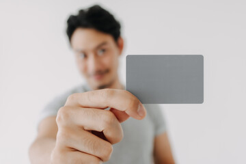 Happy man showing close up empty card to focus on the card.