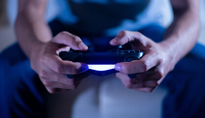 close up hand of young man playing video game holding controller