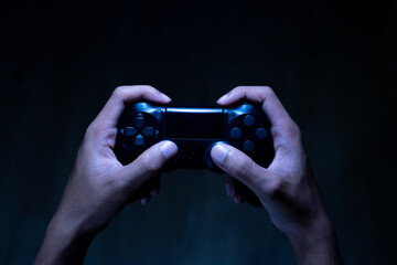 Fototapeta premium close up hand of young man playing video game holding controller