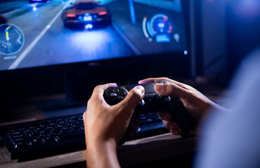 close up hand of young man playing video game holding controller