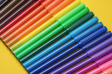 Coloring fibre felt tip pens arranged in a row. Assorted color's doodling markers