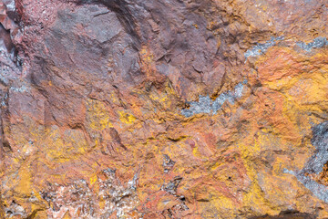 The colorful texture of natural rock. Rough stone texture background