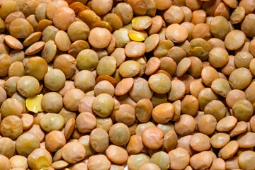 Closeup photo of natural dried brown lentils rotating