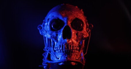 Robotic skull with blue and red lights and smoke
