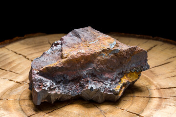 A piece of solid hematite with its rough texture. The natural raw stone of great healing power - obrazy, fototapety, plakaty